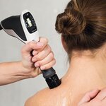 Chiropractor performing radial shockwave therapy on a patient’s upper back and neck at Spine Align Chiropractic & Wellness in Huntsville