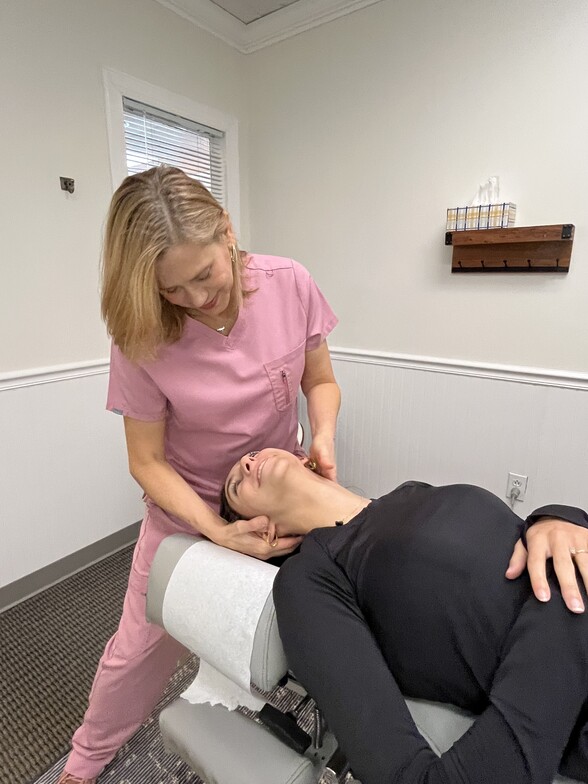 Chiropractor adjusting patient neck