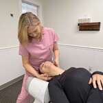 Chiropractor adjusting patient neck