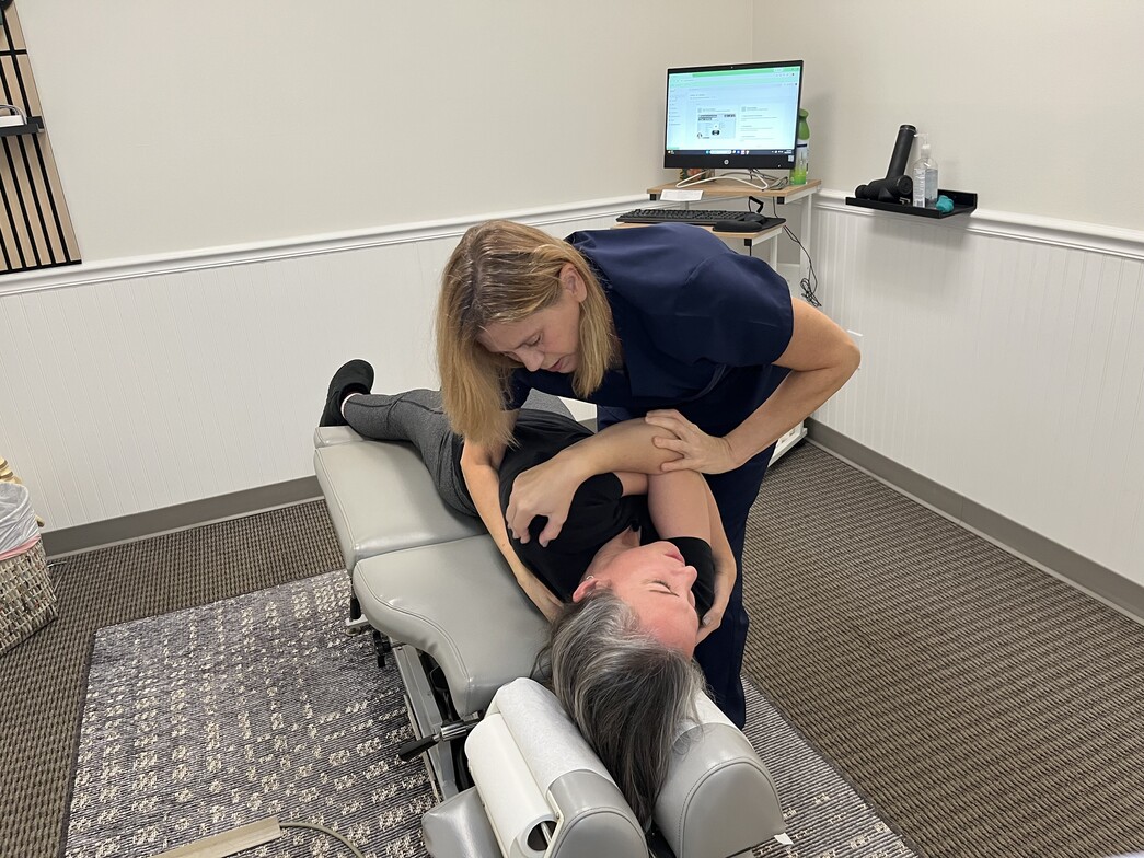 Chiropractor Performing Thoracic Adjustment