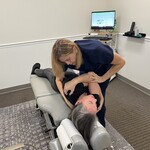 Chiropractor Performing Thoracic Adjustment