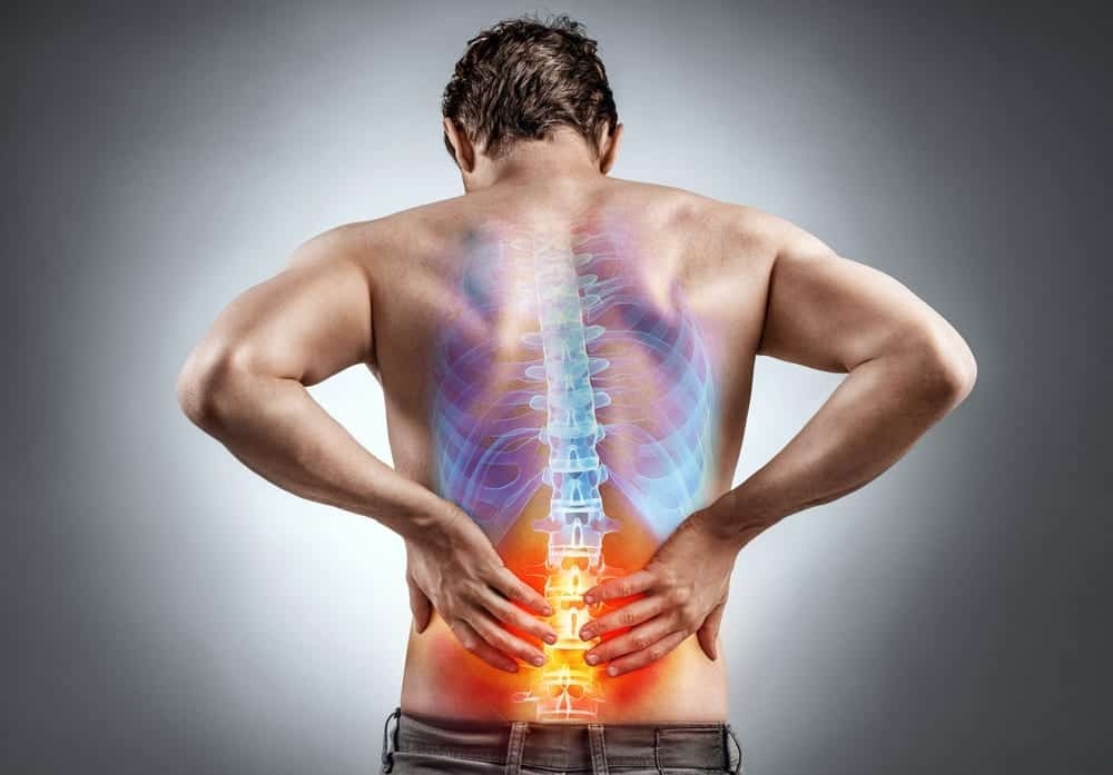 Man grabs low back in pain