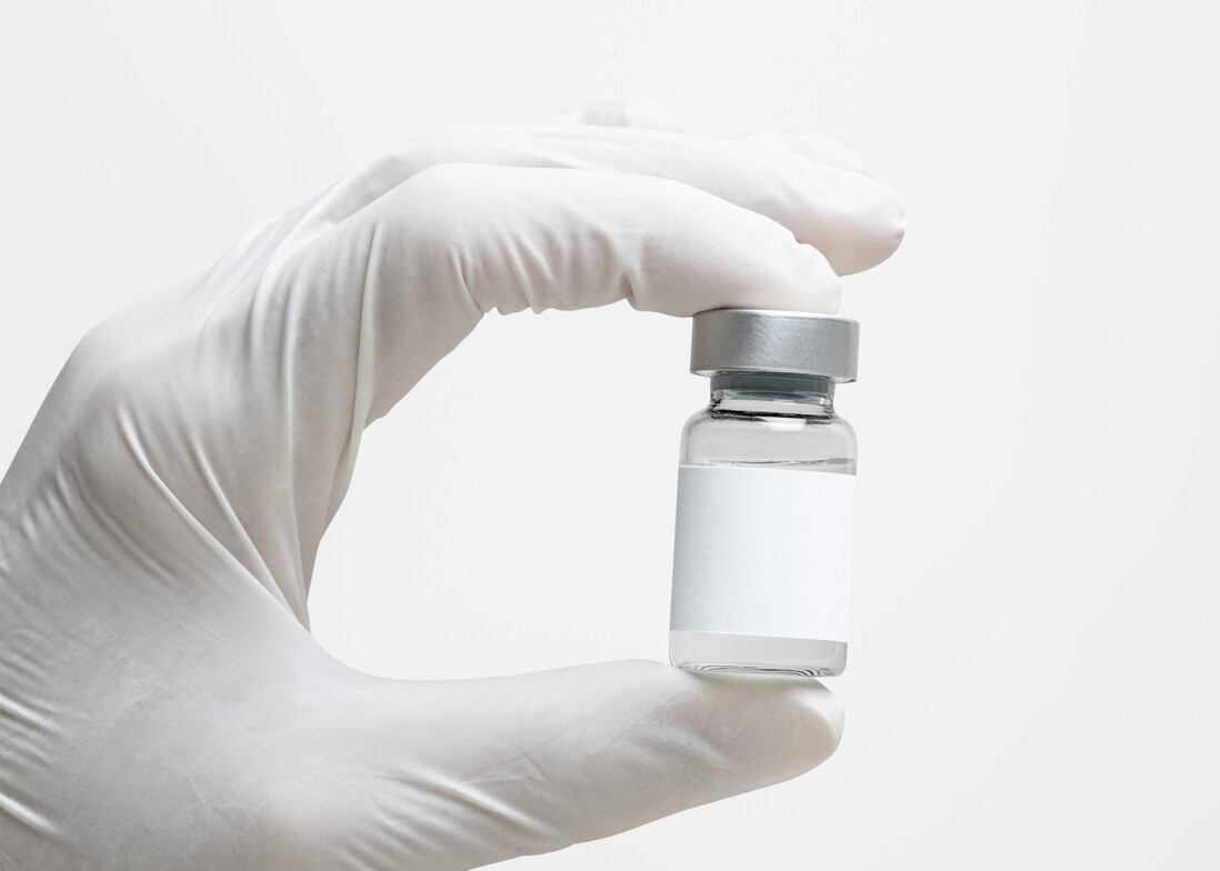 scientist_hand_holding_medicine_glass_bottle_blank_label