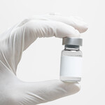 scientist_hand_holding_medicine_glass_bottle_blank_label