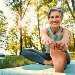 Active older woman stretching outdoors as part of a healthy lifestyle.