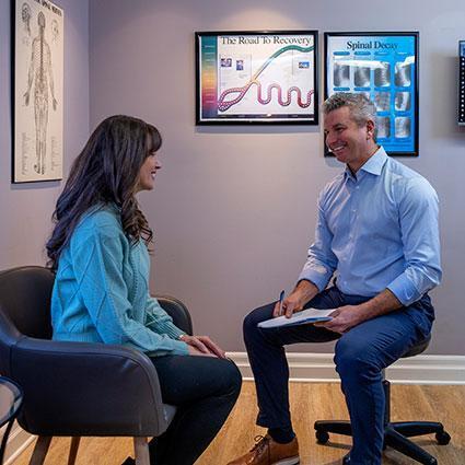 Doctor discussing a chiropractic treatment plan with a patient